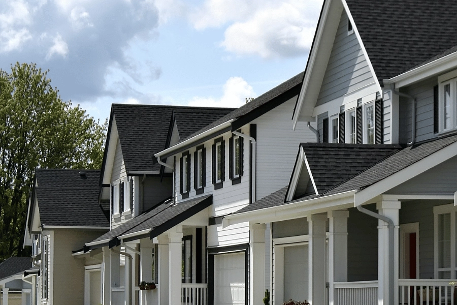 Row of nice homes with front porches on a suburban street 